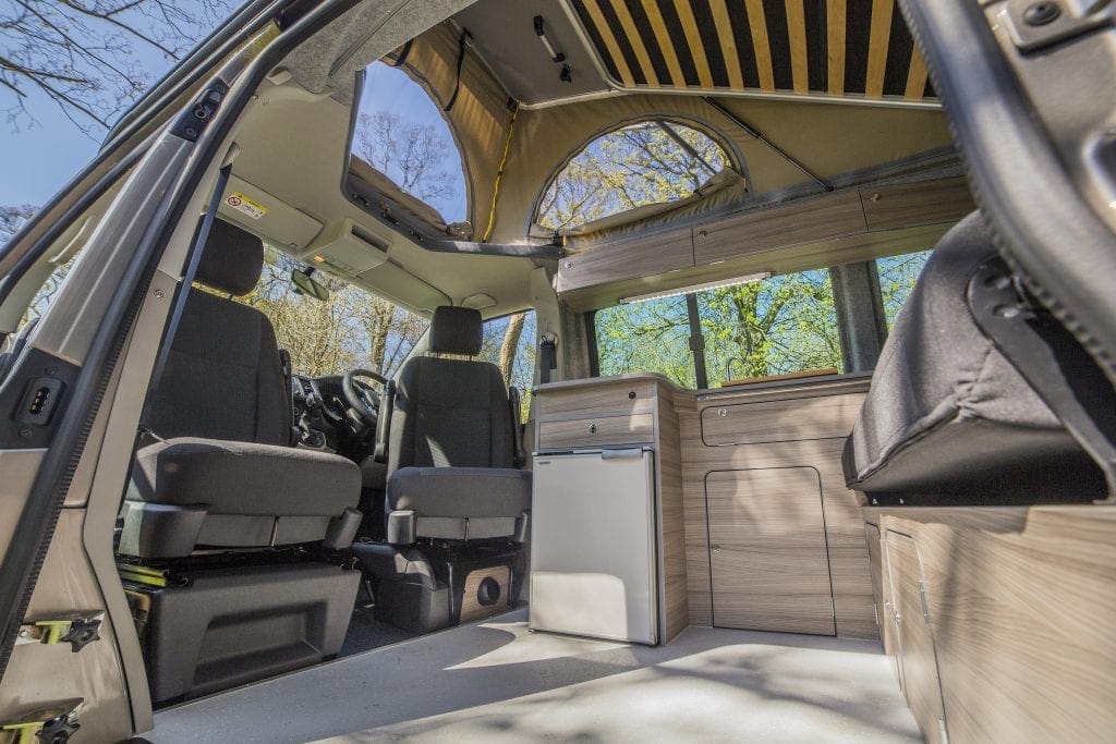 Bright Campervan Interior with seats, cupboards and windows