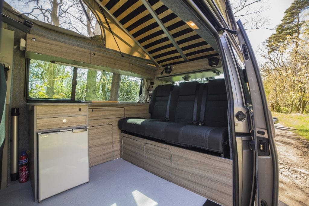 Campervan Interior - black seats, bright coloured cupboards and windows