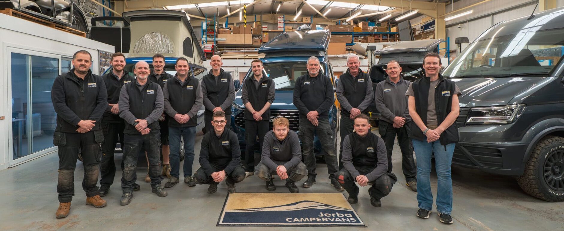 Jerba Campervan team infront of Ford Transit Custom a VW T7 and a Volkswagen Crafter at our workshop in Scotland