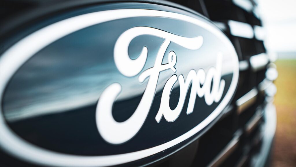 A close up of the front badge of an All New Ford Transit Custom van.
