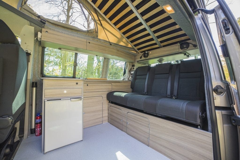 Inside the Volkswagen Tiree Campervan - Black seats and wooden interior