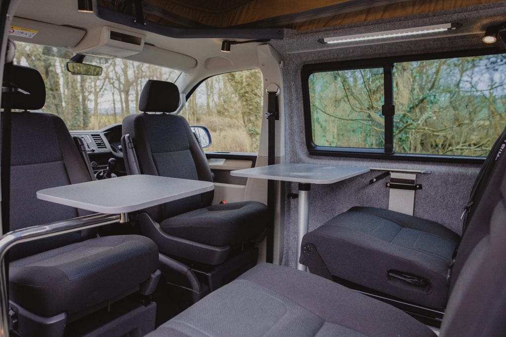 Campervan Interior - tables and seats in the middle