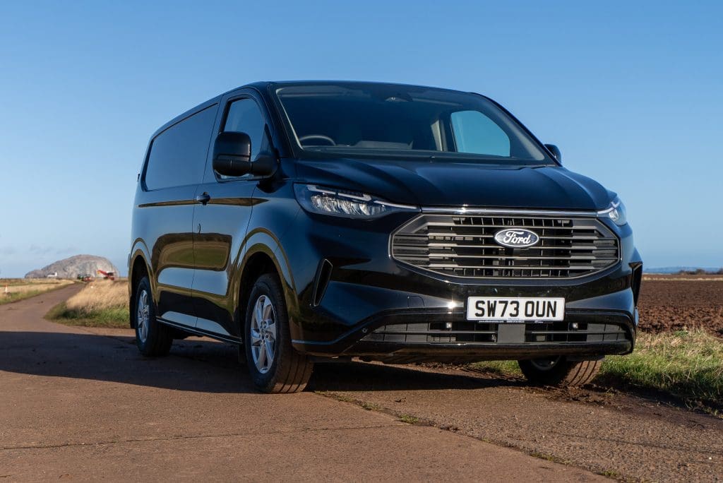 Black All New Ford Transit Custom Van in field in East Lothian with Bass Rock in background