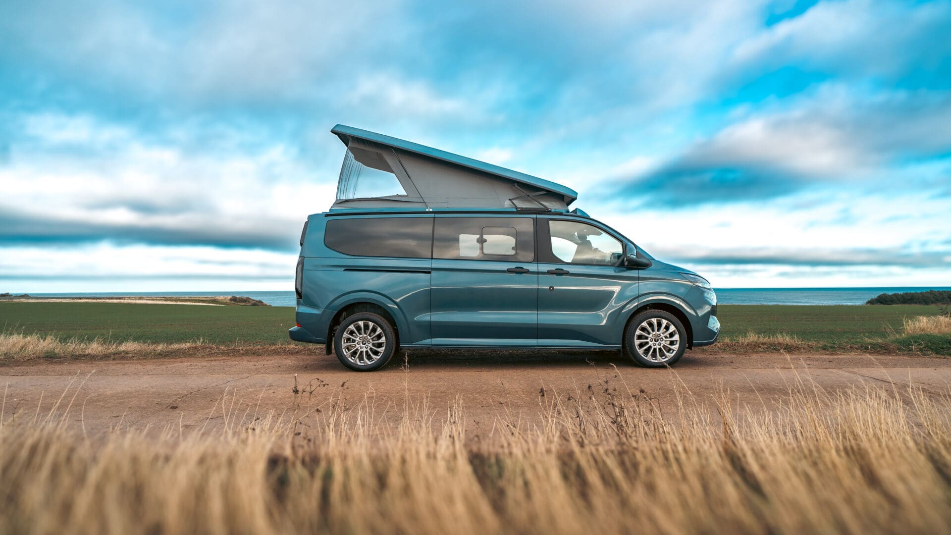Ford Transit Custom Campervan parked on a road on a sunny day in Scotland