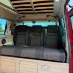 Rear seats of a Red 2023 VW T6.1 Transporter Jerba Campervans Tiree Conversion.