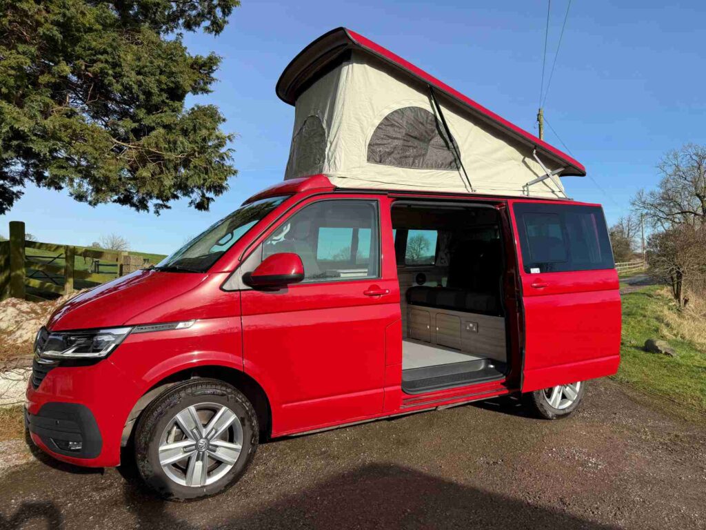 Side view of a Red 2023 VW T6.1 Transporter Jerba Campervans Tiree Conversion.