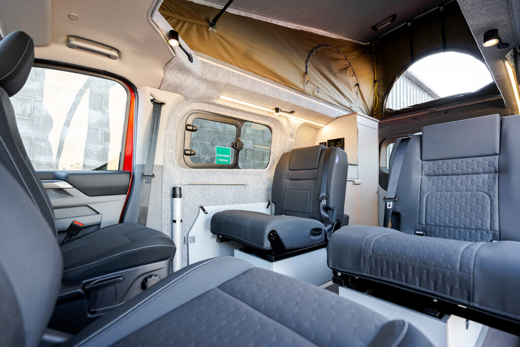 Rear Seats of a Red 2026 Ford Transit Custom Campervan, Jerba Sanna, 1000 Miles.