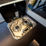 Kitchen Hob of a Red 2026 Ford Transit Custom Campervan, Jerba Sanna, 1000 Miles.