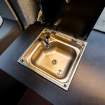 Kitchen Sink of a Red 2026 Ford Transit Custom Campervan, Jerba Sanna, 1000 Miles.