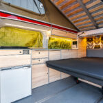 Rear Bed of a Red 2026 Ford Transit Custom Campervan Jerba Cromarty, 5000 Miles.