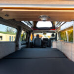 Table Stowed in a Red 2026 Ford Transit Custom Campervan Jerba Cromarty, 5000 Miles.