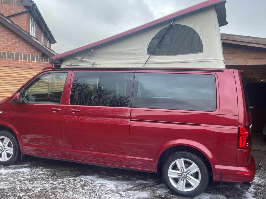 Elevating roof of a Red VW Transporter T6.1 Campervan Jerba Sanna, 19,000 miles.