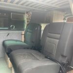 Rear Seats of a Red VW Transporter T6.1 Campervan Jerba Sanna, 19,000 miles.