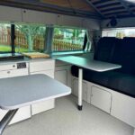 Tables of a Red 2020 VW Transporter T6 Campervan Jerba Cromarty, 17,000 Miles.