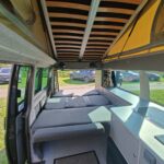 Rear Bed of a Blue VW Transporter T5 2011 Campervan Conversion, 94000 miles.