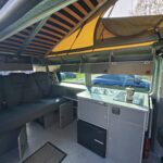 Elevating Roof of a Blue VW Transporter T5 2011 Campervan Conversion, 94000 miles.
