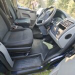 Driver Seat of a Blue VW Transporter T5 2011 Campervan Conversion, 94000 miles.
