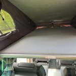 Elevating Roof Bed of a Beige 2013 VW Transporter T5 LWB Campervan, 87,000 Miles.